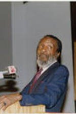 Dick Gregory is shown speaking at a Southern Christian Leadership Conference Spring Board meeting held at Grace Temple Baptist Church in Detroit, Michigan.