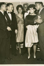 Jackie and Rachel Robinson are shown standing with Nelson Rockefeller and others guests at the Testimonial Dinner held for Robinson at the Waldorf Astoria in New York City on July 20, 1962.