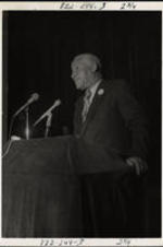 E.L. Simon speaking at an event.