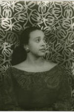 Portrait of Adele Addison in front of a patterned background. Written on verso: Photograph by Carl Van Vechten; 146 Central Park West; Cannot be reproduced without permission; April 8, 1955.