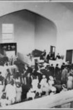 Joseph E. Lowery is shown standing at a pulpit in front of a congregation in an unidentified church.