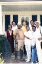 C. Eric Lincoln stands with guests on a porch outside of Alex Haley's house in Tennessee.