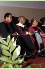 Platform participants (President, Board of Trustees, and Deans) sit while watching the proceedings of the graduation ceremony.