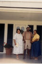 C. Eric Lincoln stands with two other women on a porch outside of Alex Haley's house in Tennessee.