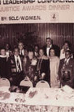 Joseph and Evelyn Lowery, Congressman John Lewis (on left), Coretta Scott King (middle), Maya Angelou (back right), and others are shown posing for a picture with Drum Major for Justice Award recipients. Written on verso: 4-4-92-3 31