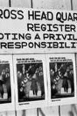 Sign on a building reading, "Cross headquarters, register, voting a privilege, a responsibility".