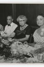 Elenor Roosevelt, Rufus Clement and others seated at a banquet table. Written on verso: Love Mother, 6/4/62, Mother on Mrs. Roosevelt's left.