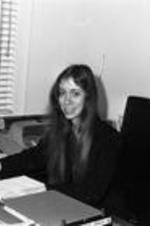 An unidentified woman sits at her desk in a VEP office.