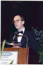 An unidentified man speaks at the podium at the Atlanta Student Movement 20th anniversary event.