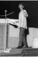 Poet Atukwei John Okai presents onstage.