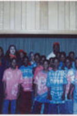 Evander Holyfield, SCLC/W.O.M.E.N. members, and children pose for a photograph.