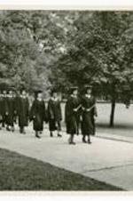 View of 1948 Commencement procession. Written on verso: Dr. Helen T. Albro, Esther Perrin, and June Dobbs, leading the procession.