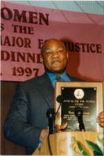 George Foreman poses for a photo holding his Drum Major for Justice Award he received at the 18th Annual SCLC/W.O.M.E.N. Drum Major for Justice Awards dinner.