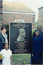 Reverend James Orange (on left), Evelyn G. Lowery, Albert Turner, Jr. (on right), and others are shown posing for a picture at the dedication ceremony for Albert Turner, Sr.'s historical marker.