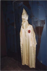 A Ku Klux Klan robe in an exhibit case.