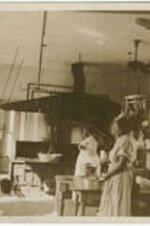 Two women stand in the kitchen in North Hall.