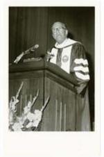 President Hugh Gloster speaking at a podium. Written on verso: President Hugh M. Gloster Founder's Day - Feb. 19, 1981.