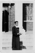 Anna E. Hall standing on steps.