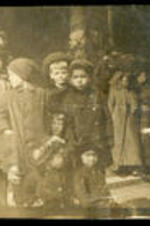Group of children outside with hats and coats.
