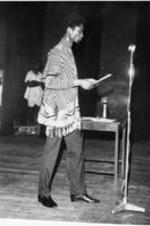 Poet Atukwei John Okai presents onstage.