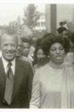 President Hugh Gloster walking with Leontyne Price. Written on verso: Campus Visit of Leontyne Price.