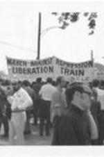 A group of people prepare for the start of the march and hold a large banner that reads "March Against Repression Liberation Train, SCLC." Written on accompanying document: March Against Repression 5-23-70 began at Ebernezer - ended Morehouse College - marchers assymbling.