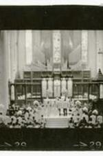 Inside of Cathedral during the wedding ceremony of Beth A. Chandler and Theodore John Warren in 1964. Written on verso: An abbreviated view of the wedding principles at the cathedral's altar rail - brother Mickey assisted with the ceremony. Wedding Ceremony of Beth Chandler - Theodore John Warren, Jr.