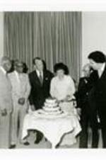 President Hugh Gloster with wife Dr. Beulah Gloster, Dr. Benjamin Mays, Judge George Crockett, Dr. Gloster, T.M. Alexander Sr., Maynard Jackson, and Dr. Calvin Brown Jr. cutting Founder's Day cake.