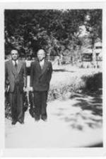Two men standing outside. Written on verso: Left to Right Bishop S. Mordol and Bishop John A. Sulhan (my Bishop). Bishop Sulhan is coming to US soon.