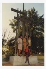 Outdoor group portrait of four women standing on sculpture sign "Morris Brown College".
