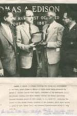 A picture of George Wallace presenting a plaque to John Edison Sloane with an image caption and brief note to Elizabeth McDuffie.