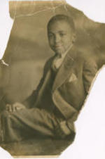 A portrait photo of Joseph E. Lowery at twelve years of age, shown in a suit. Written on verso: 12 yrs of age.