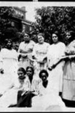 A group of Neighborhood Union Women gather in a yard.