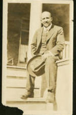 Portrait of W.E.B. Dubois sitting on a porch.