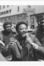 Hosea Williams speaks while a group surrounds him at the Sanitation Worker's Strike in Atlanta. Written on accompanying document: Hosea Williams speaking during march of sanitation strikers.