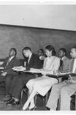 A group of students seated at desks in a classroom. Written on verso: Graduating seniors include Edgar L. Mack and Calvin C. Lawton.