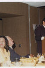 A unidentified speaker at a legislative seminar. Coretta Scott King sits with others at the front table.