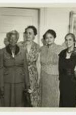Indoor group portrait of seven women.
