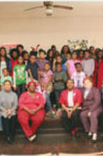 Ruby Shinhoster, Karen Reagle, and other SCLC/WOMEN members pose for a picture with a group of children during a SCLC/W.O.M.E.N. Bridging the Gap: Girls to Women Mentoring Program event at Christmas time. Written on verso: Bridging The Gap, Xmas 2012.