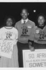 Students at Augusta College are shown holding protest signs that state "Why Send Children To Do S. Africa's Dirty Work!" and "So. Africa Kills Black Children In Soweto:...". Written on verso: SCLC Condemns Apartheid -- Black students at Augusta College in Augusta, Georgia deplore the college's refusal to cancel a concert appearance there by a South African boys' choir and join with SCLC in staging a protest demonstration that attracted national attention.