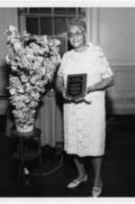 Gertrude Anderson receives an award. Written on verso: Gertrude Anderson 1971 Dormitory Hostess.