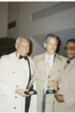 Otis Moss, Julian Bond, and an unidentified man hold awards at the Atlanta Student Movement 20th anniversary event.
