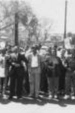 From left to right in the first row (beginning fifth from the left), Dick Gregory, Martin Luther King, III, John Nettles, Coretta Scott King, Joseph E. Lowery, Evelyn G. Lowery, and Jesse Jackson lead demonstrators at the 25th Anniversary Selma to Montgomery March.  Written on verso: Marching up the streets of Montgomery headed to the state capitol on the 25th Anniversary of the Selma/Montgomery March. Leading the line Johnny Ford, student from Kelly Miller High School in D.C., Rev. John Alford President SCLC Dayton (?) Chapter, Rev. Raleigh Trammell, SCLC National Board Member, SCLC Board Member Dick Gregory, SCLC Board Member Martin Luther King, III, Regional V. Pres. Rev. John Nettles, Mrs. Coretta Scott King, Joseph E. Lowery, Mrs. Evelyn Lowery, Rev. Jesse Jackson, Melba Moore.