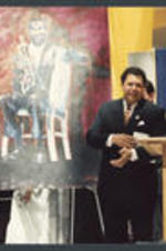 Maynard Jackson stands in front of a painting.
