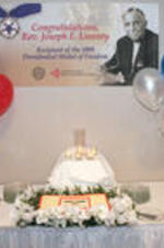 A decorated cake and banner that are part of a Hartsfield-Jackson Atlanta International Airport event congratulating Joseph E. Lowery on receiving the 2009 Presidential Medal of Freedom.