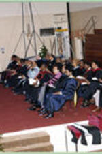 Platform Participants (President, Board of Trustees, and Deans) listen to a commencement address.