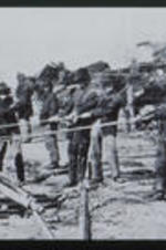 Men help rebuild railroads after the end of the Civil War. Text from slide presentation: In the closing months of the Civil War, Union troops destroyed most railroads in Georgia