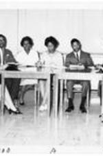 Christian Education class, seated in classroom. Written on verso: (L to R) Mrs. Carrie George, Mr. Robert Thomas, Mrs. Myra Taylor, Miss Lydia Tucker, Isaac Richmond, Miss Lillie Bell Speel, Alexander Sherman.