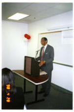 Dr. L. Henry Whelchel speaks behind a podium in a classroom.