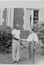 Dr. Harry V. Richardson shakes a student's hand.